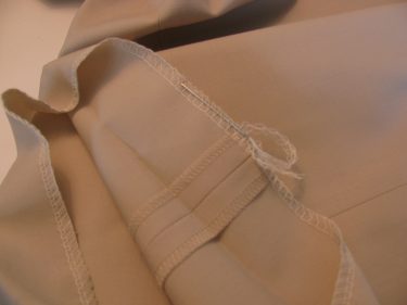weaving a thread tail back into serged edge, hem pants and skirts, 069