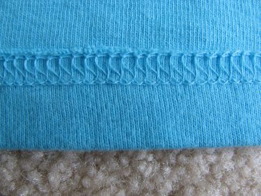 back side of cover stitch on a knit top, 136