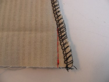 red stitching line showing how to take out some fabric on flared leg hem, 190