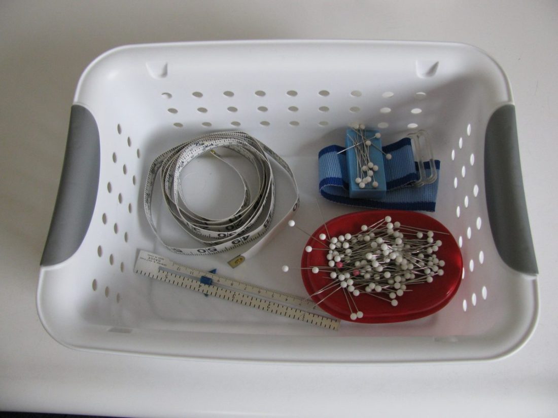 white plastic basket full of notions, 675