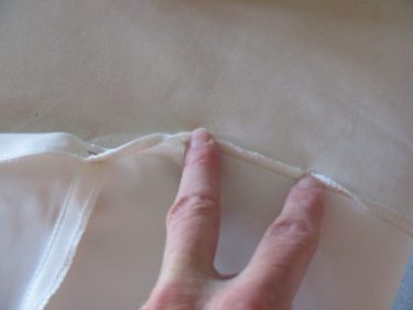 taking out stitches to do a partial hem on a wedding dress, 682