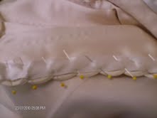 putting satin tape over loops on a wedding dress