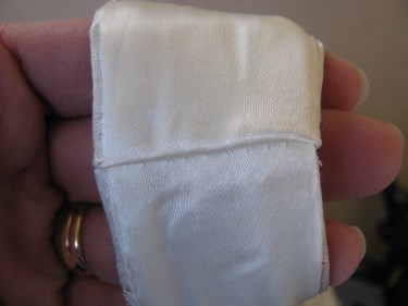 close up of the lining side of the wide shoulder strap, taking up the shoulder strap