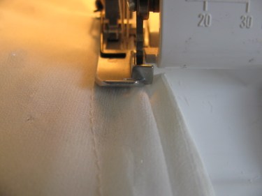 serge off excess from seam on blouse, 1003