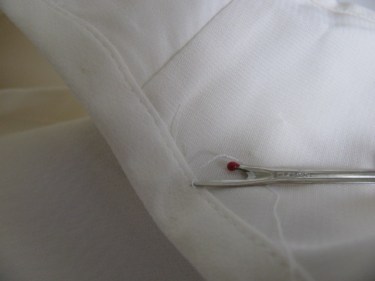 using a seam ripper to take off binding from a blouse, 1010