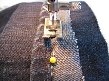 stitching the hem circle back onto the jeans higher up the leg