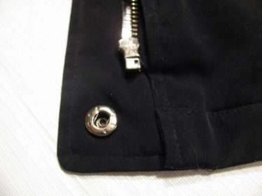showing the lower end of the zipper and black jacket after the new zipper is sewn in, sewing blog 1412