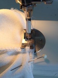 stitching the collar back to the neck edge, 1373