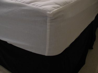 close up of corner on mattress pad on bed