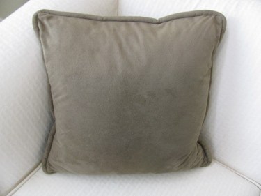green pillow with piping