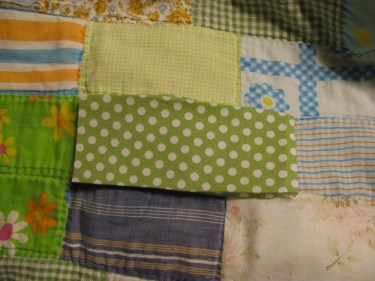 a new piece of fabric bigger than the one I need to replace. It has a green background with whtie polka dots