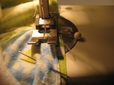 machine stitching one side of the new piece into the quilt