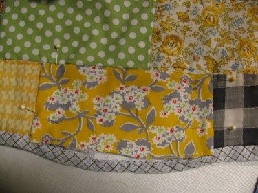 The new piece is pinned down and then stitched in place along the bottom of the quilt 8865