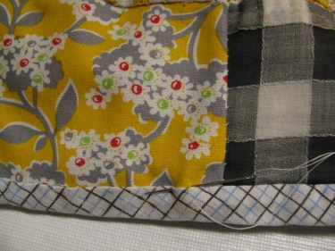 8867, stitching the binding back onto the quilt with hand stitches